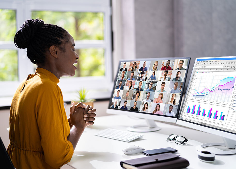 Future of remote working | woman in yellow shirt talking in a virtual meeting with multiple people