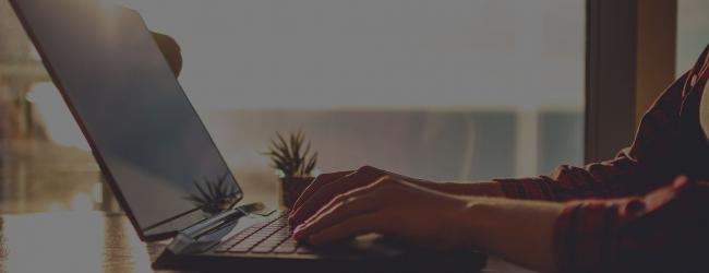 Close up of person typing on their laptop