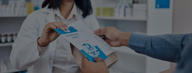 Pharmacist handing person their medicine